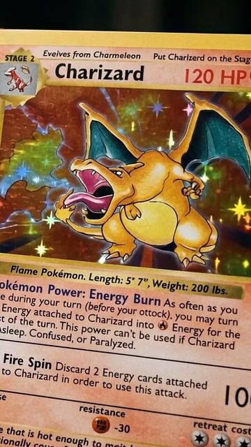 A Charizard holographic card under the lights